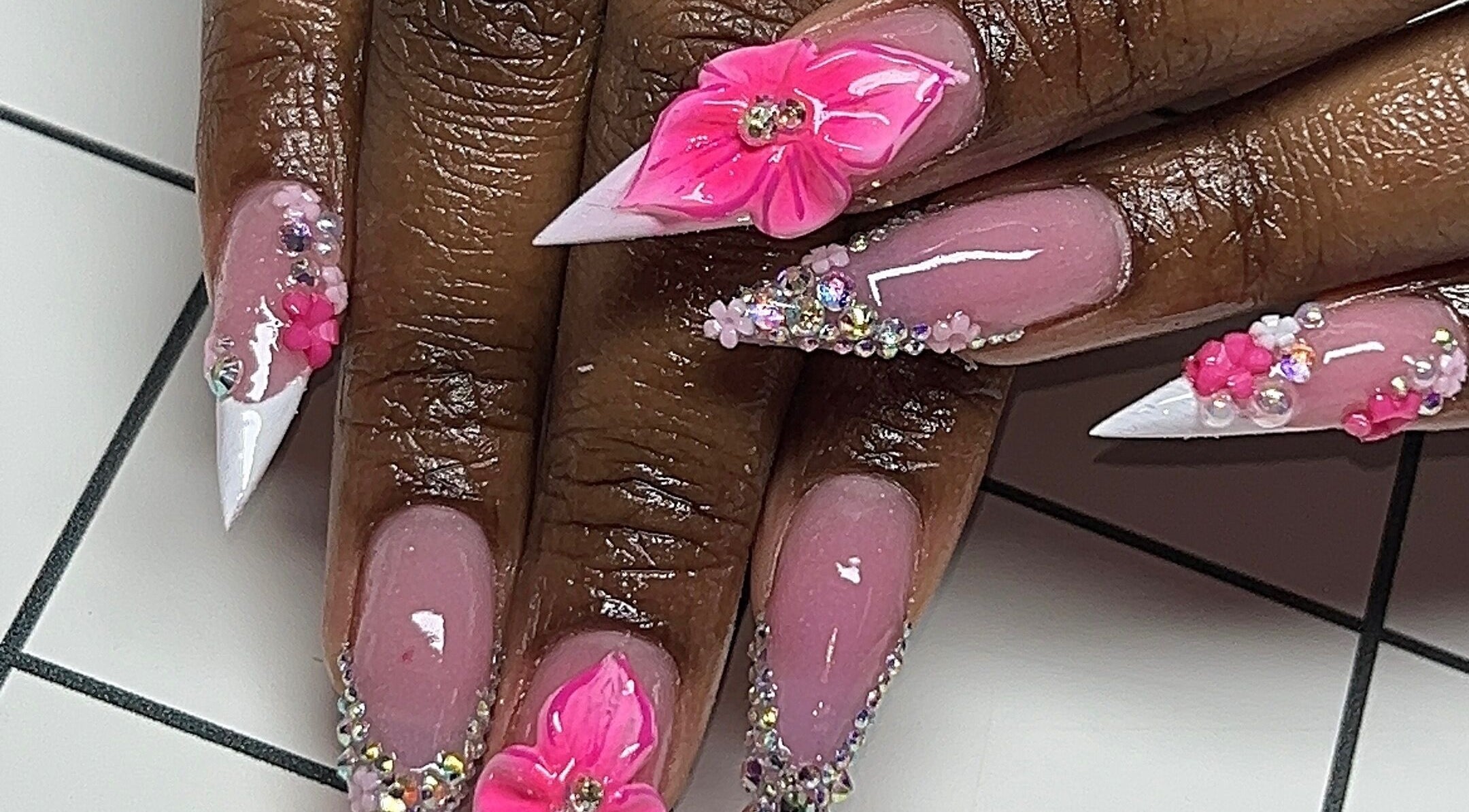 Detailed pink floral nail art at Rx Nailz, Brampton, Ontario, CA showcasing elegance and craftsmanship.