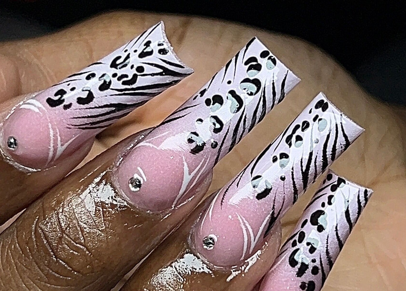 Elegant zebra-inspired nail art at Rx Nailz, Brampton, Ontario, CA, with pink and black design accents.