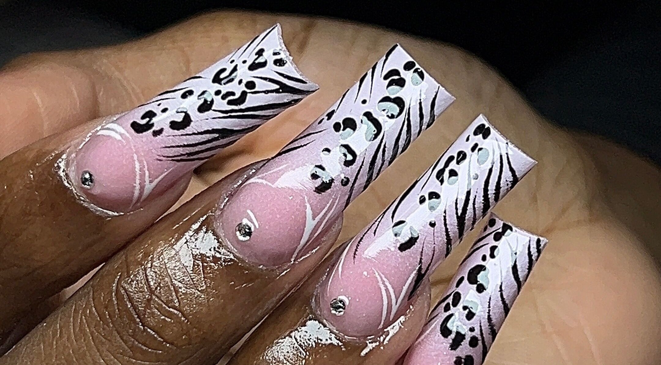 Elegant zebra-inspired nail art at Rx Nailz, Brampton, Ontario, CA, with pink and black design accents.