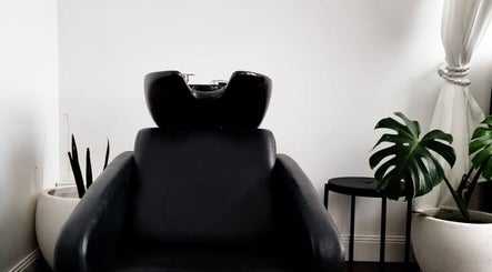 Comfortable shampoo chair at Jacqueline Louise Hair, Sydney, New South Wales, AU, with modern decor and plants.