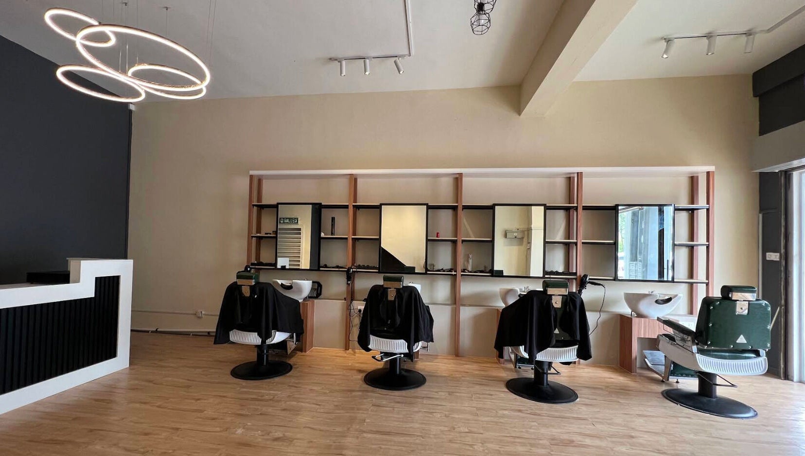 Sleek interior of Manros Hair Studio, Cyberjaya, Selangor, MY showcasing stylish salon chairs and modern decor.