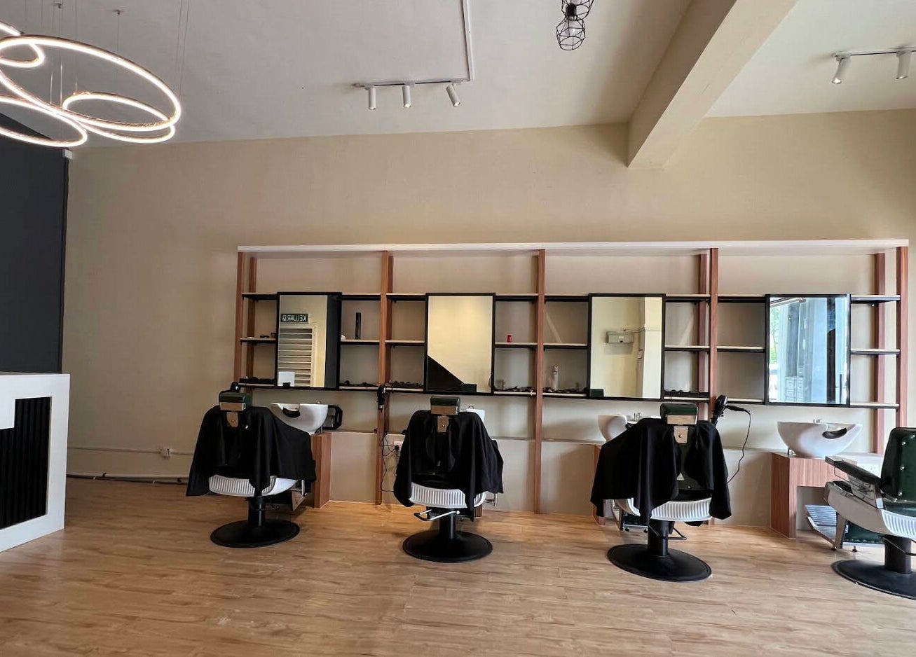 Sleek interior of Manros Hair Studio, Cyberjaya, Selangor, MY showcasing stylish salon chairs and modern decor.