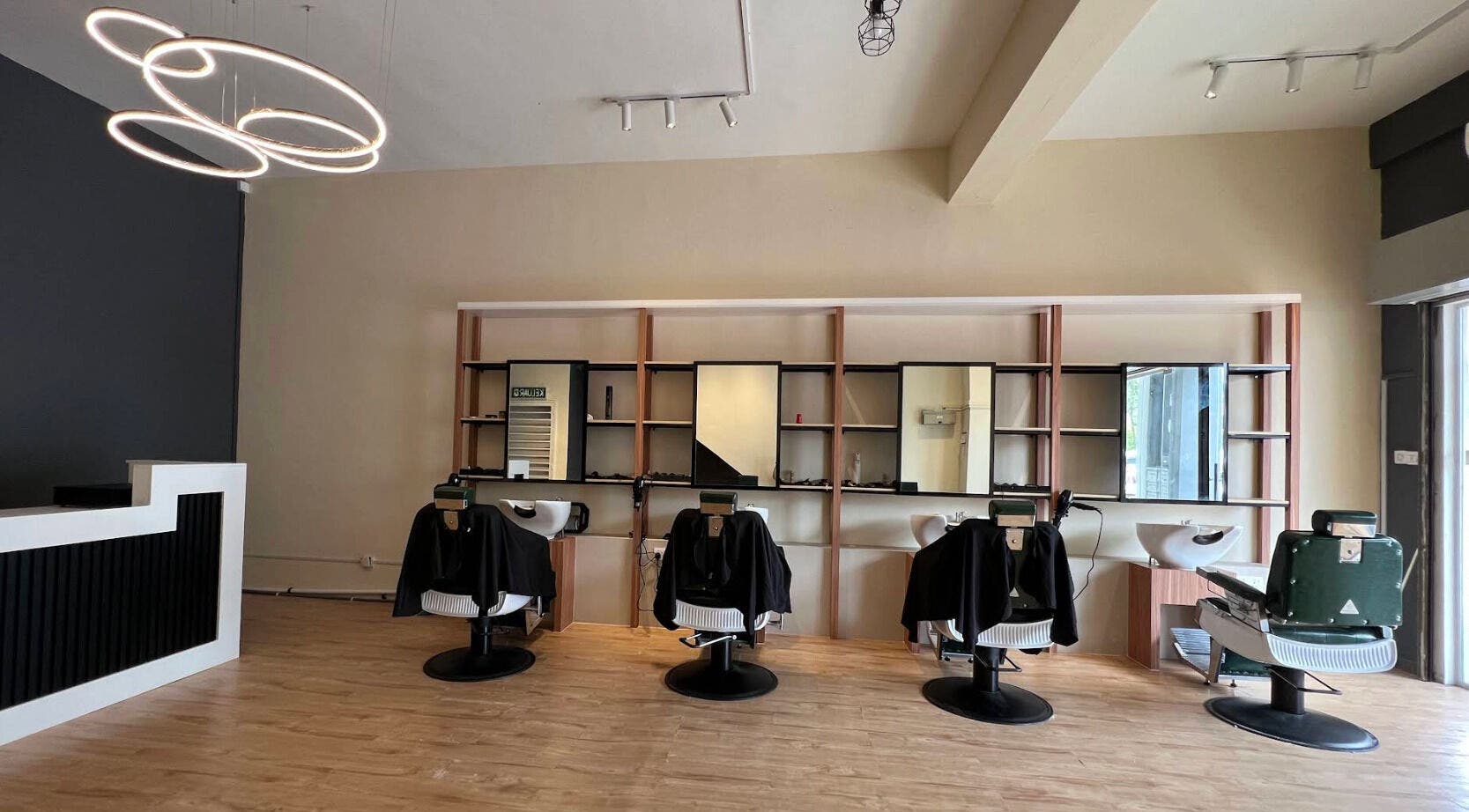 Sleek interior of Manros Hair Studio, Cyberjaya, Selangor, MY showcasing stylish salon chairs and modern decor.