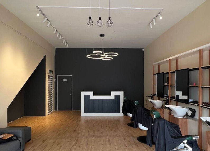 Stylish interior of Manros Hair Studio in Cyberjaya, Selangor, MY with modern decor and seating.