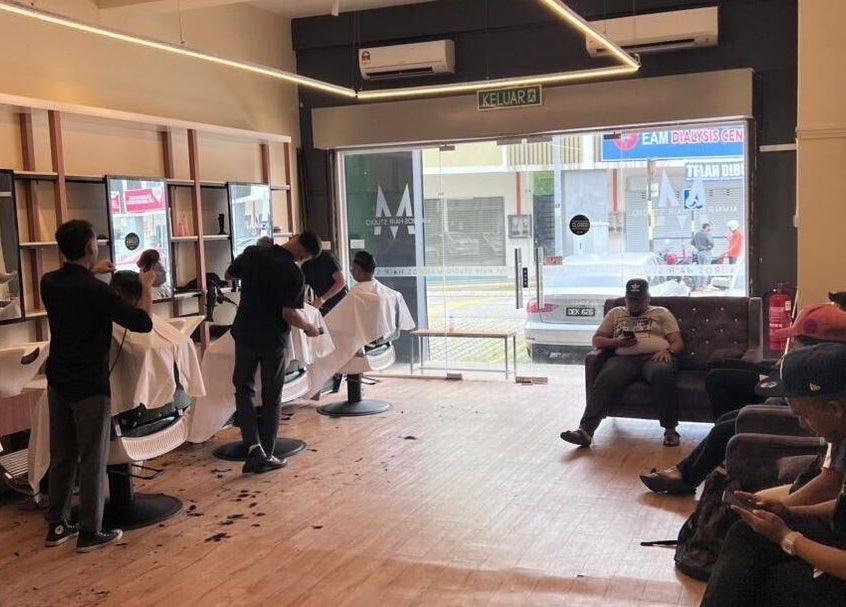 Stylish interior of Manros Hair Studio in Cyberjaya, Selangor, MY showing busy hairstylists at work.