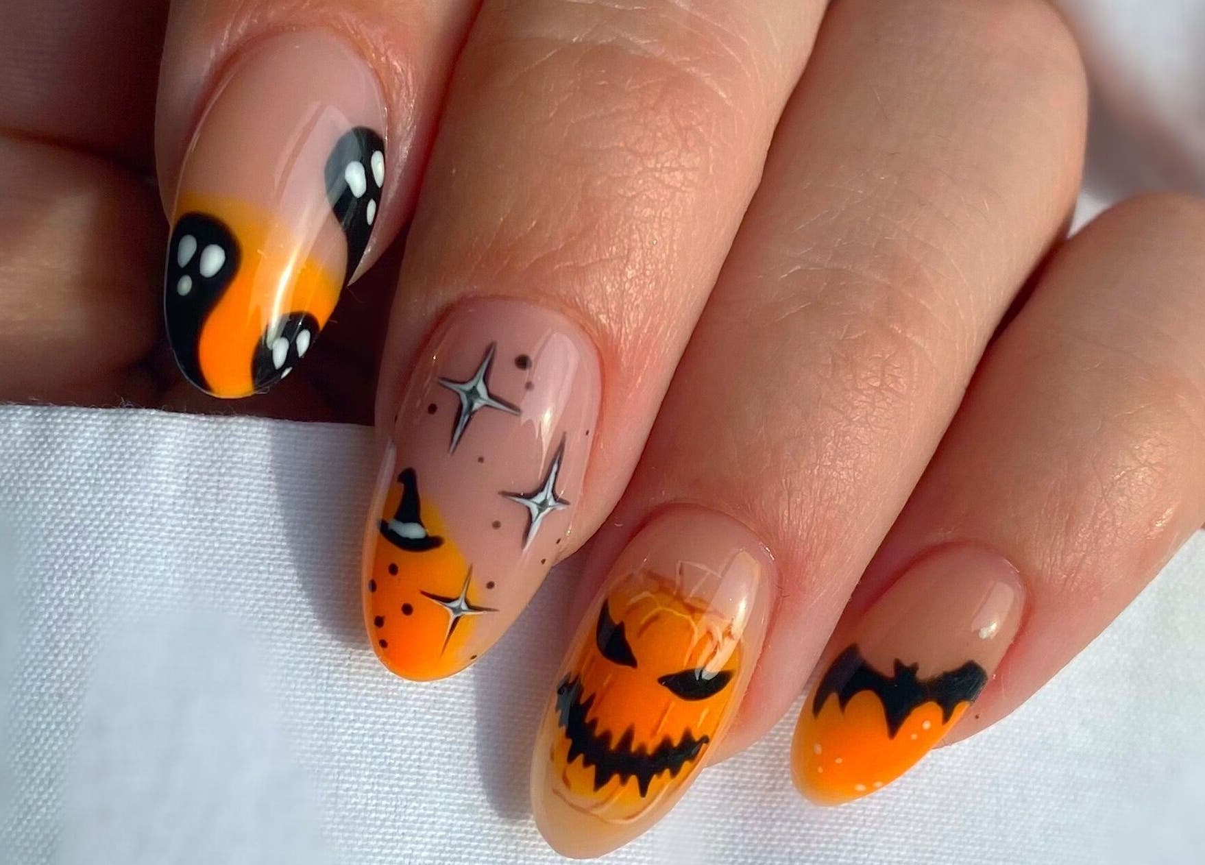 Halloween-themed nail art by Summers Nails, featuring pumpkins and stars in Kidsgrove, England, GB.