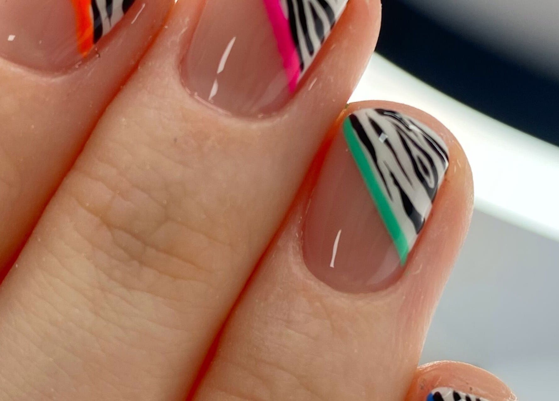 Colorful zebra nail art at Summers Nails, Kidsgrove, England, GB, showcasing vibrant and creative design.