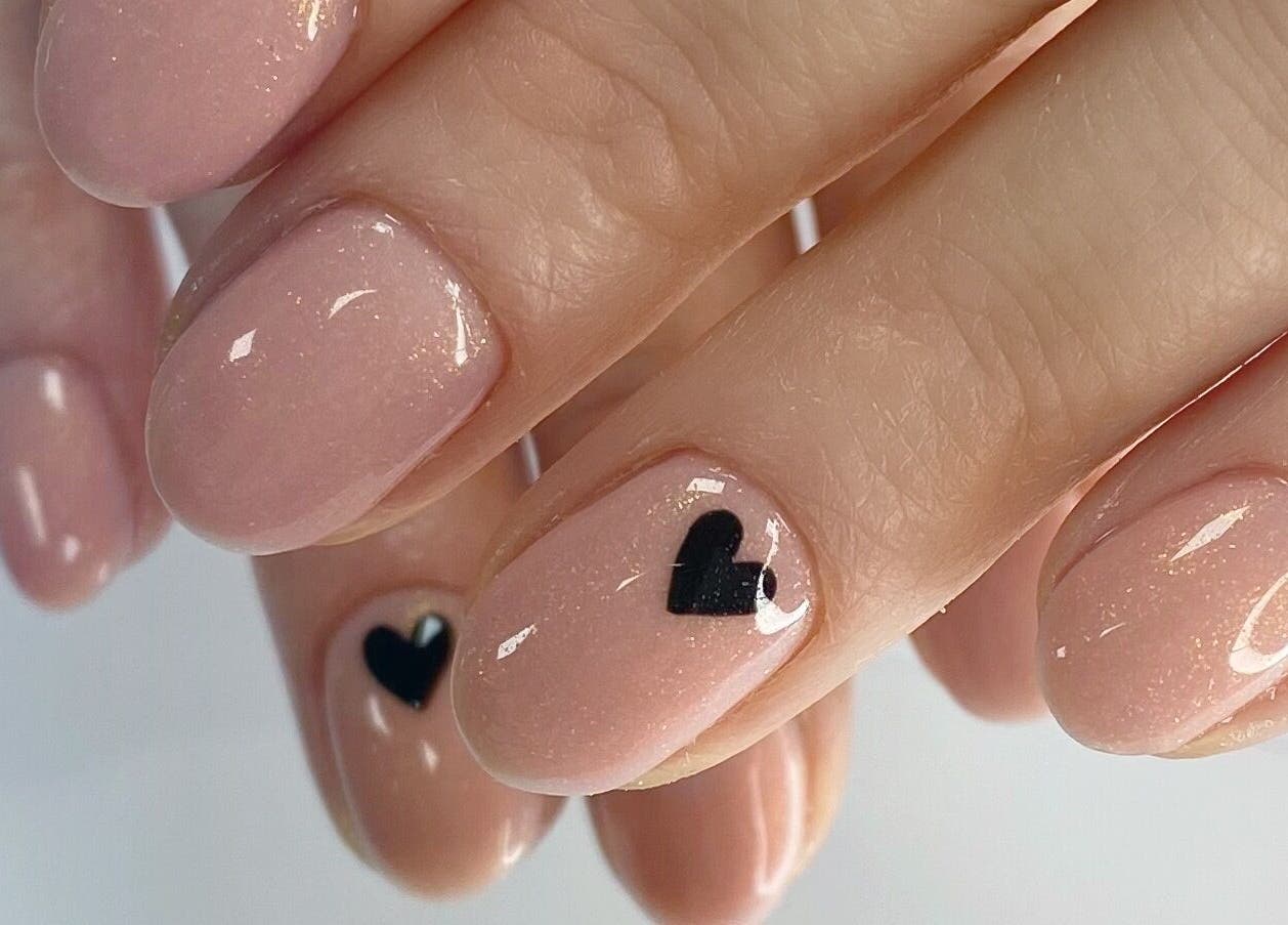 Elegant gel nails with black heart design at Summers nails, Kidsgrove, England, GB.