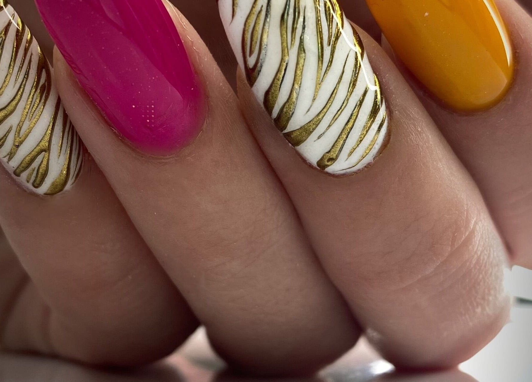 Vibrant nail art at Summers Nails in Kidsgrove, England, GB featuring pink, gold, and orange designs.