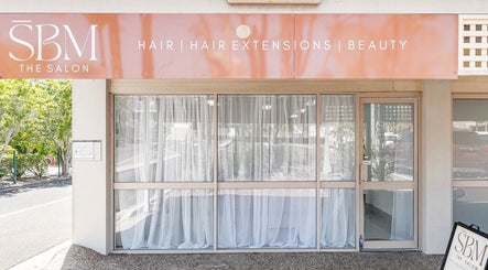 Exterior of SBM The Salon in Boronia Heights, Queensland, AU, showcasing elegant entrance and signage.