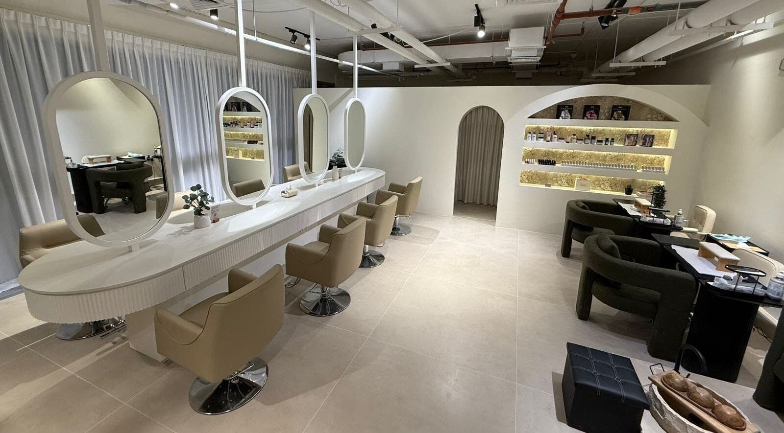 Stylish interior of Her Salon in Dubai, Dubai, AE with elegant chairs and mirrors in a calming ambiance.