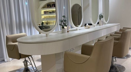 Modern beauty stations at Her Salon in Dubai, Dubai, AE featuring elegant mirrors and comfortable chairs.