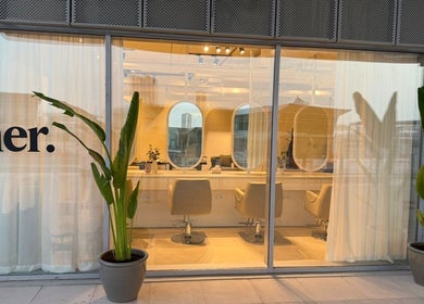 Exterior view of Her Salon in Dubai, Dubai, AE, featuring modern decor and large windows.
