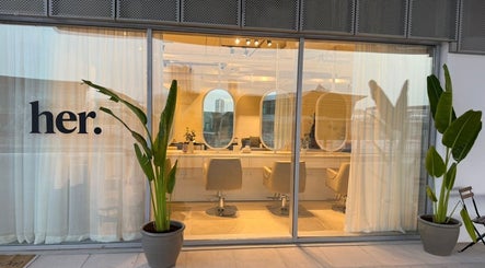 Exterior view of Her Salon in Dubai, Dubai, AE, featuring modern decor and large windows.