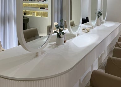 Elegant salon vanity at Her Salon, Dubai, Dubai, AE, with modern mirrors and plush chairs for a luxurious experience.