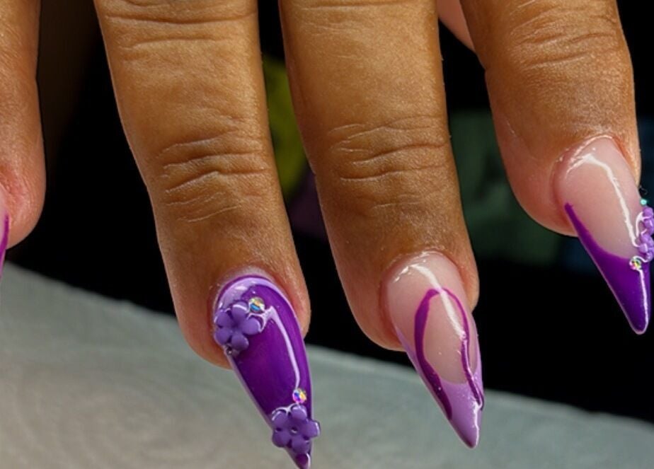 Artistic purple nails at Blossom Nails By Tash, Kralendijk, Bonaire, BQ showcase intricate floral designs.
