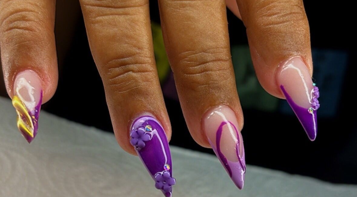Artistic purple nails at Blossom Nails By Tash, Kralendijk, Bonaire, BQ showcase intricate floral designs.