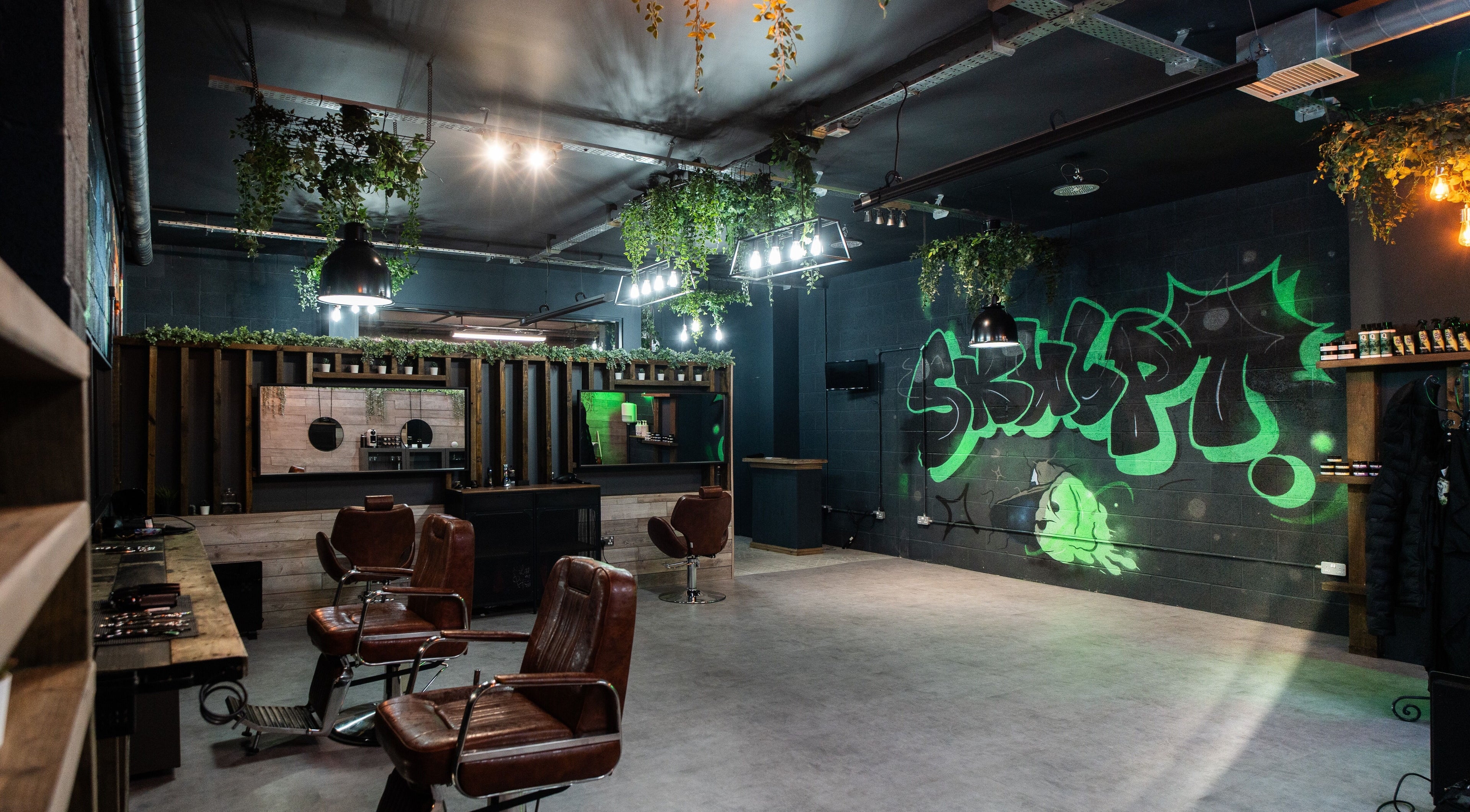 Skulpt Hair Replacement in Glasgow, Scotland, GB featuring modern chairs, graffiti, and greenery.