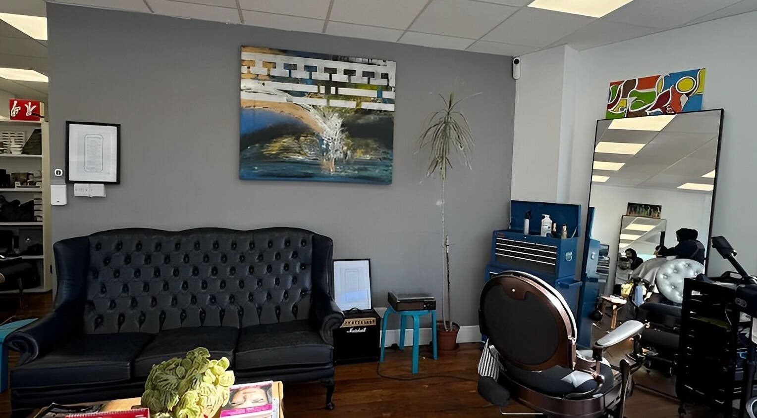 Stylish interior of Blue Barbers in London, England, GB with chic seating and modern decor.