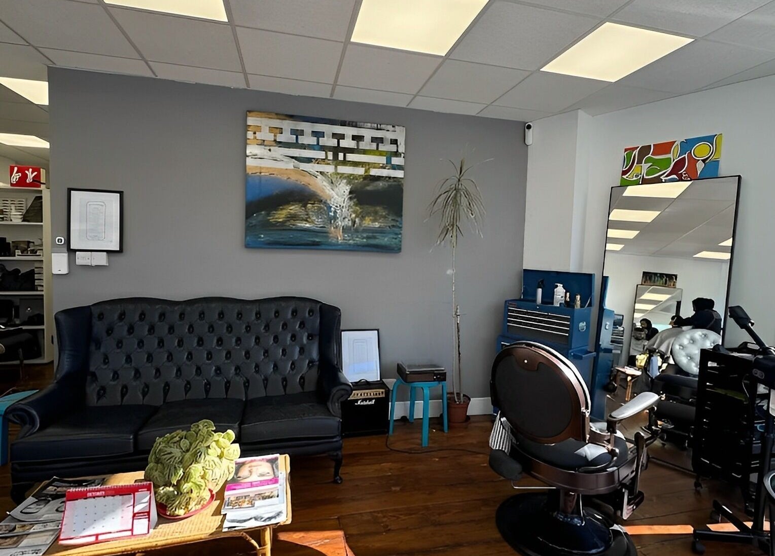 Stylish interior of Blue Barbers in London, England, GB with modern decor and comfortable seating.