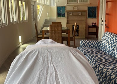 Relaxing massage room at Mobile Treatments in Saint Michael, BB featuring cozy decor and stylish furniture.