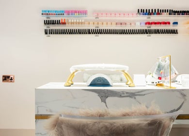 Elegant nail station at NOGTI Nails Fitzrovia, London, England, GB with colorful polish display.