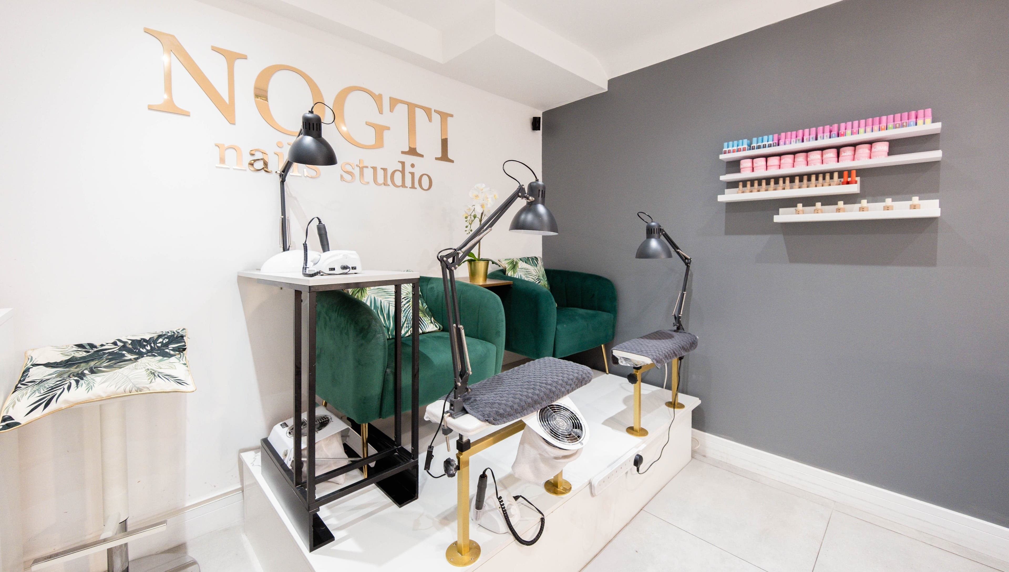 Modern interior of Nogti Nails Studio Fulham in London, England, GB with elegant chairs and nail polish shelves.