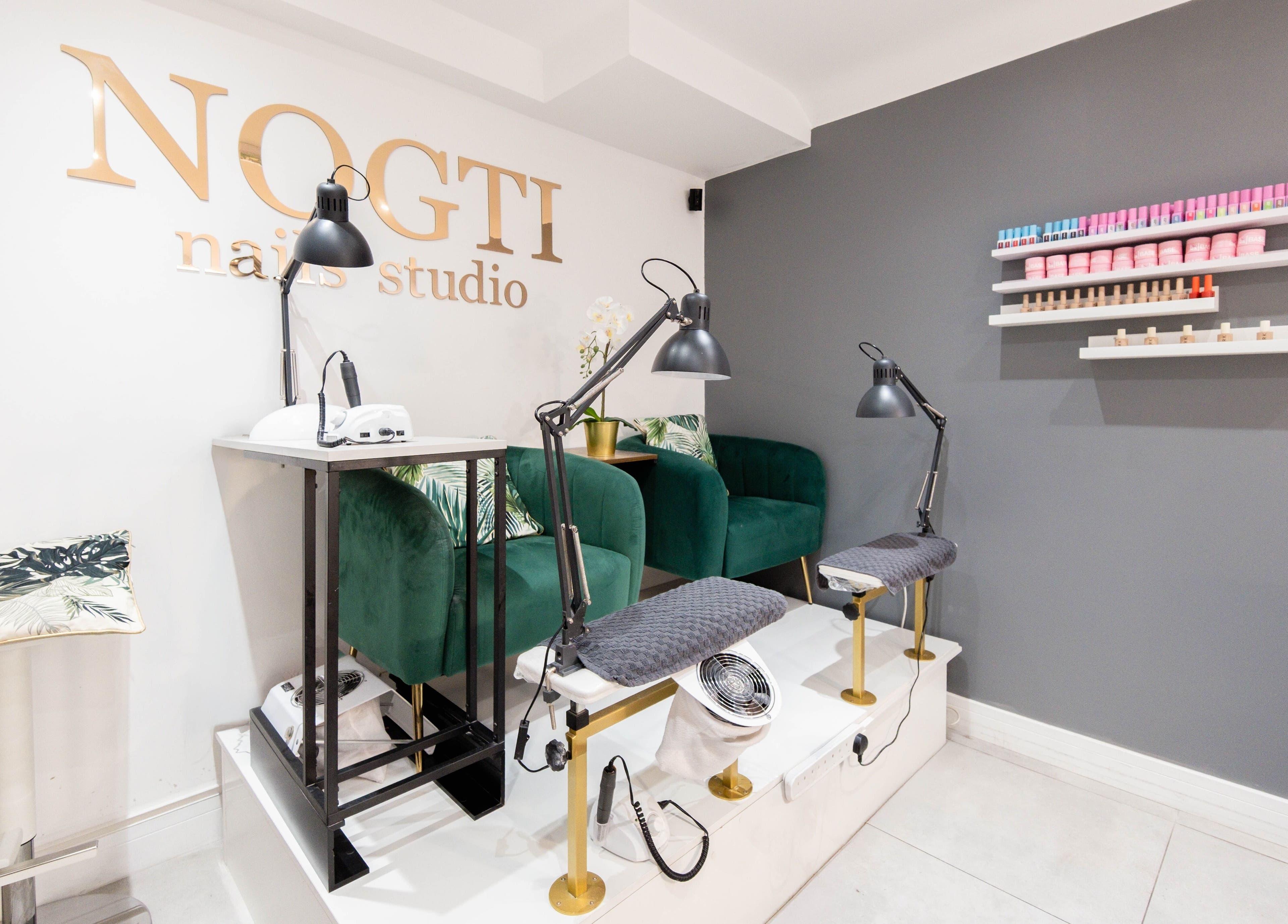 Modern interior of Nogti Nails Studio Fulham in London, England, GB with elegant chairs and nail polish shelves.