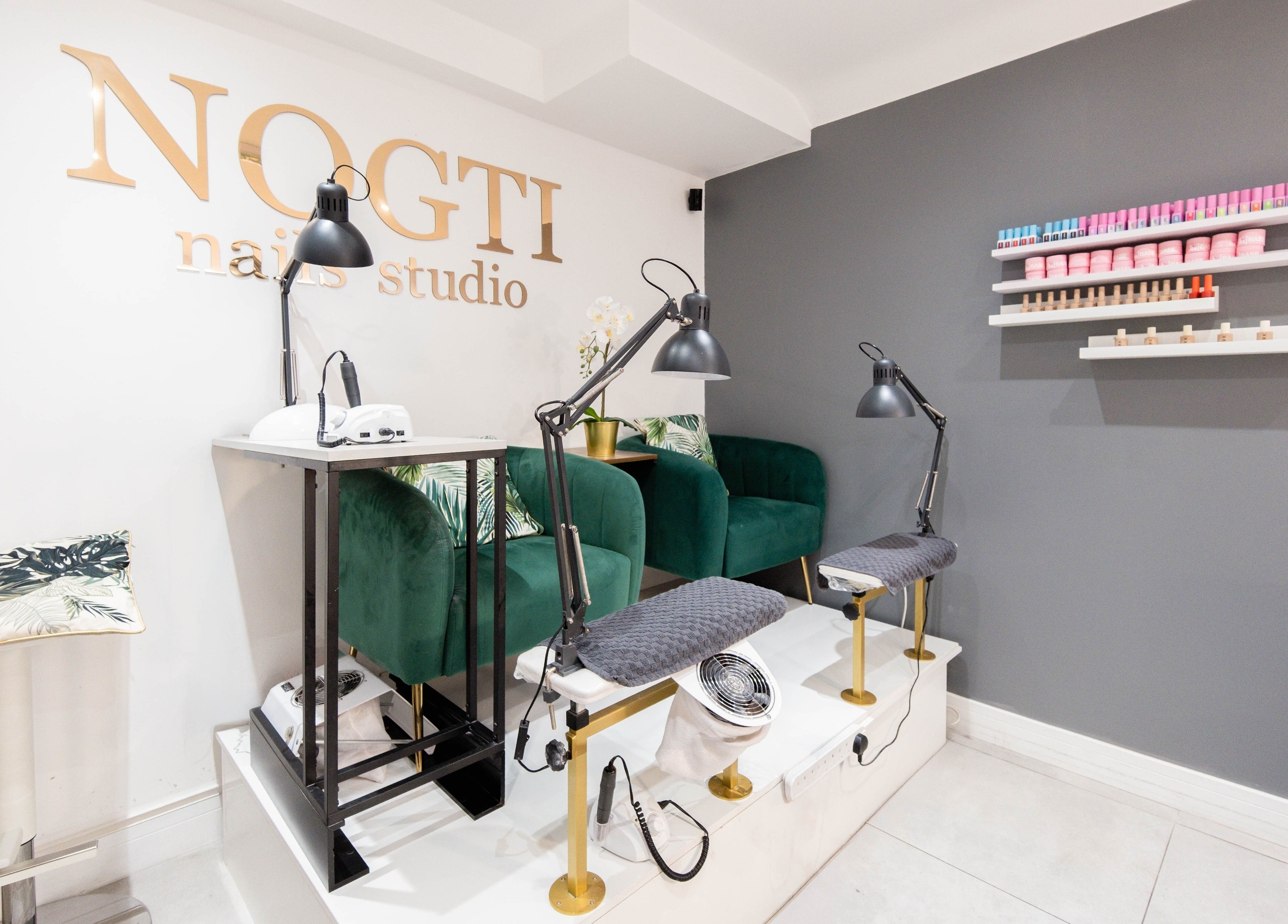 Modern interior of Nogti Nails Studio Fulham in London, England, GB with elegant chairs and nail polish shelves.