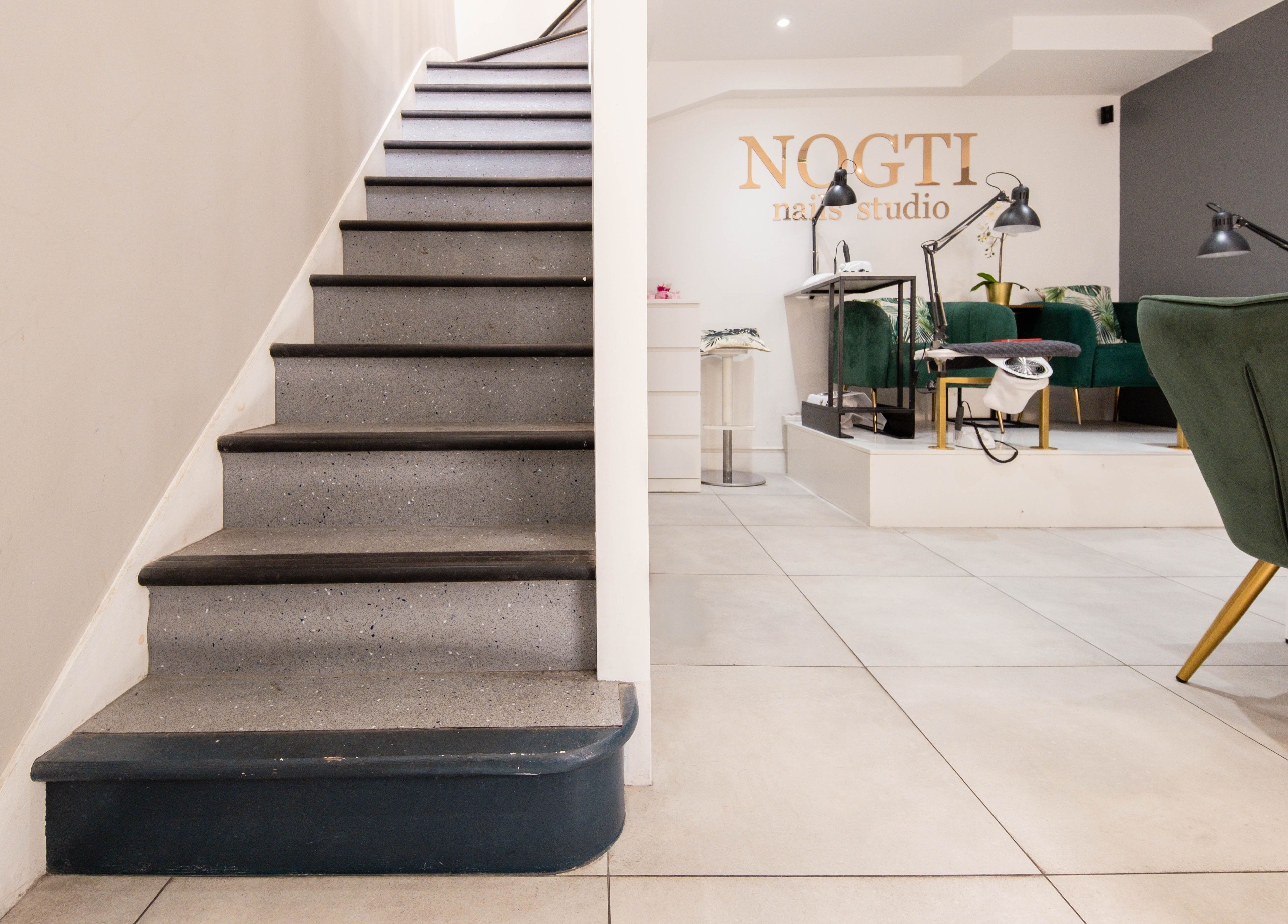 Stairway leading to Nogti Nails Studio Fulham, showcasing elegant seating in London, England, GB.