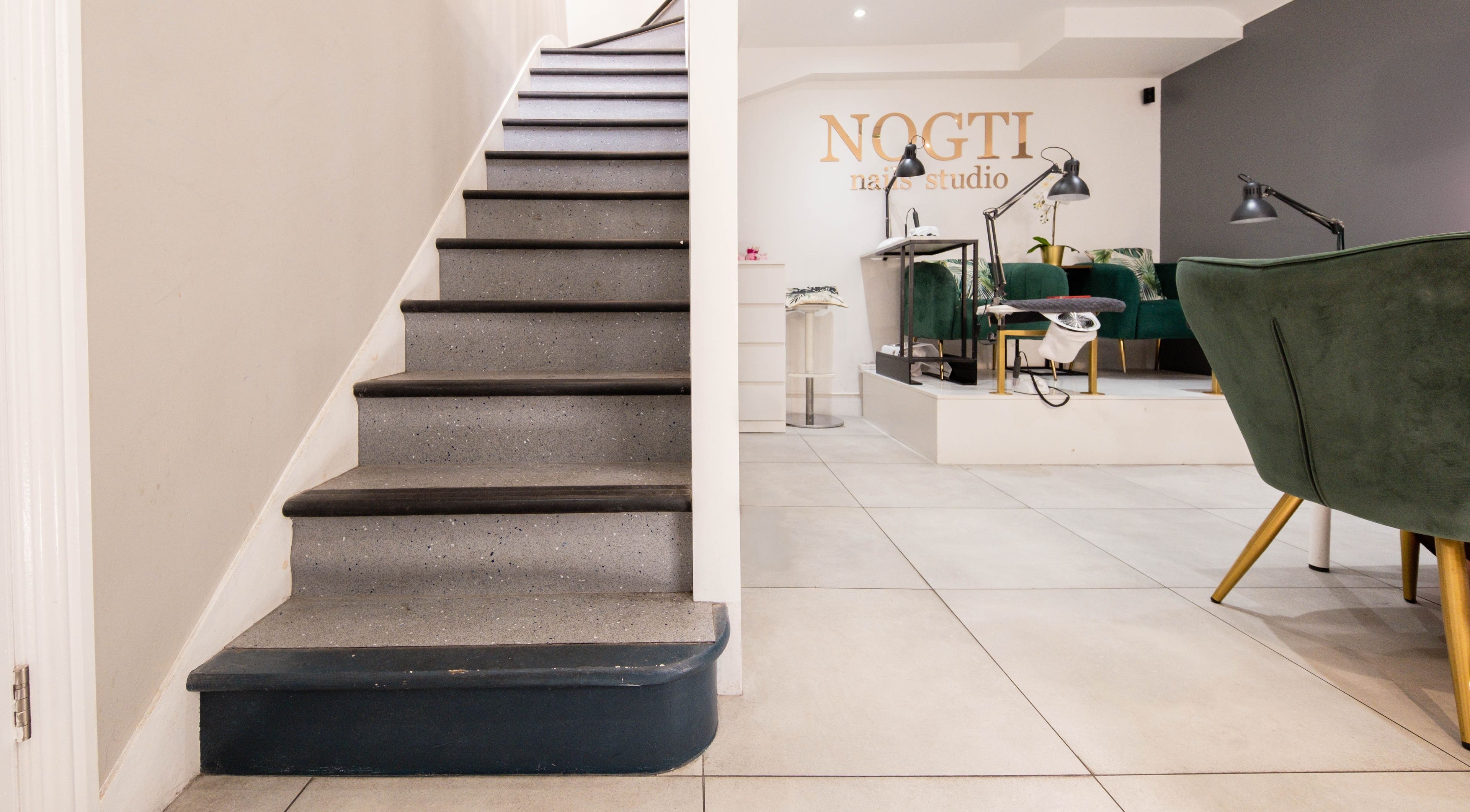 Stairway leading to Nogti Nails Studio Fulham, showcasing elegant seating in London, England, GB.