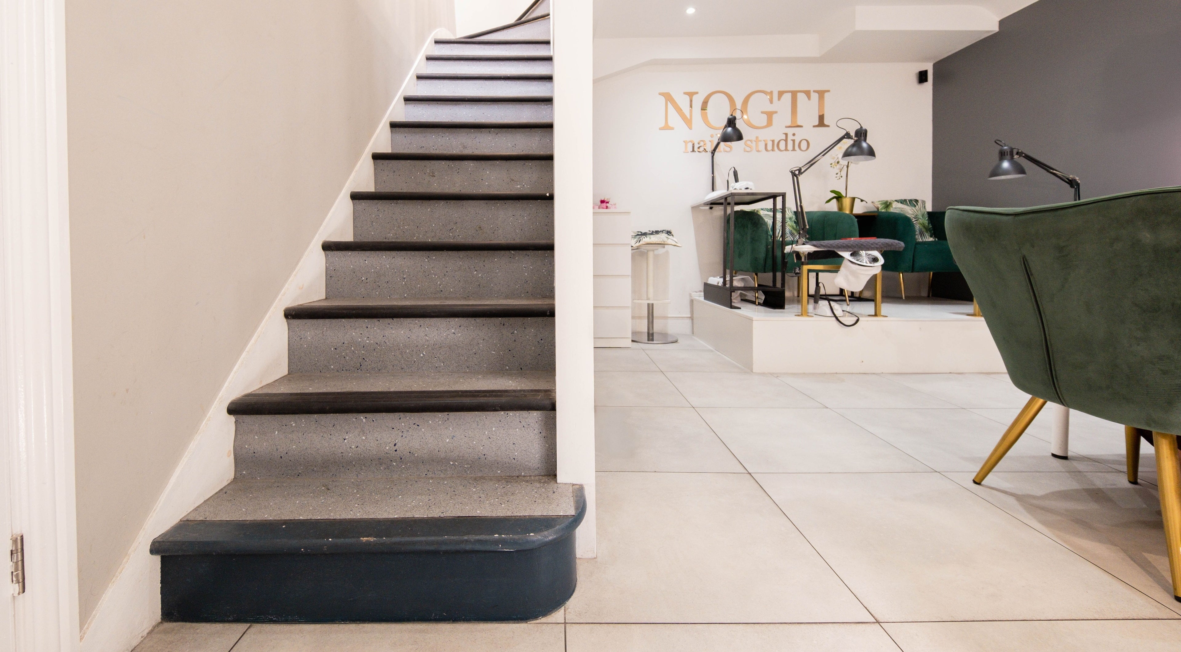 Stairway leading to Nogti Nails Studio Fulham, showcasing elegant seating in London, England, GB.