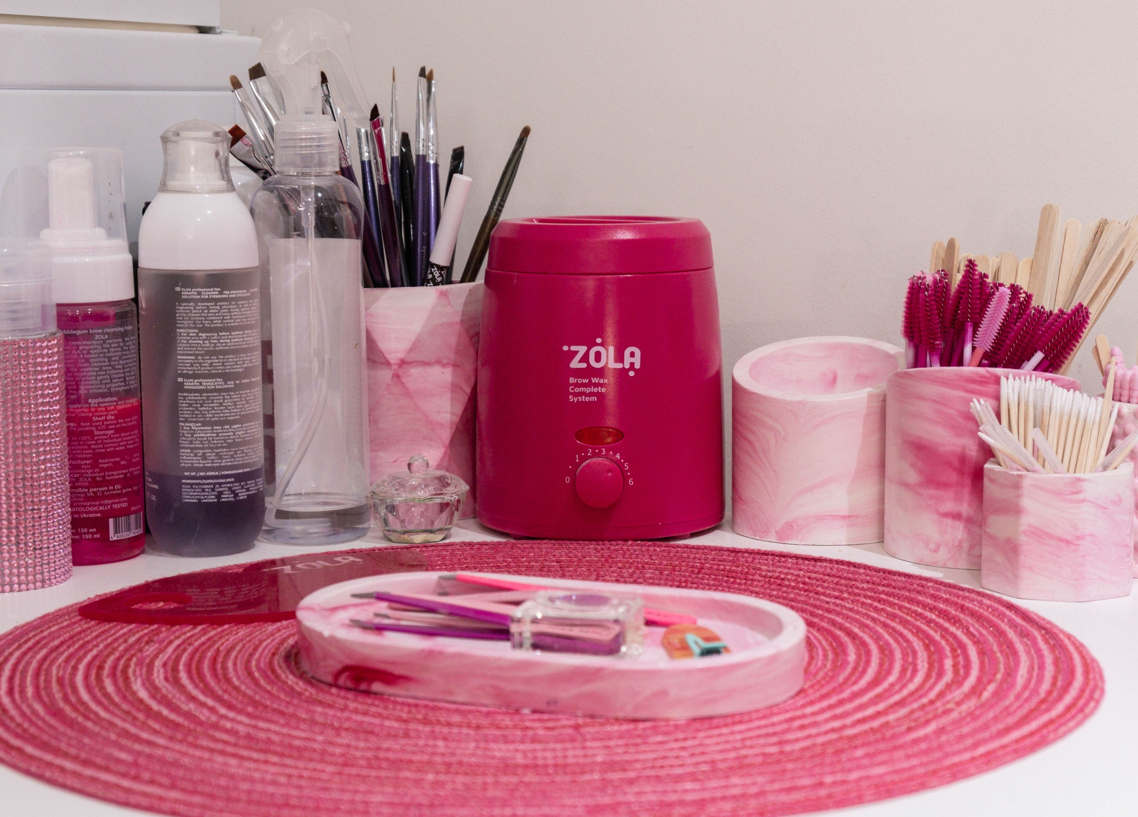 Nogti Nails Studio Fulham's pink manicure tools displayed on a pink mat in London, England, GB.