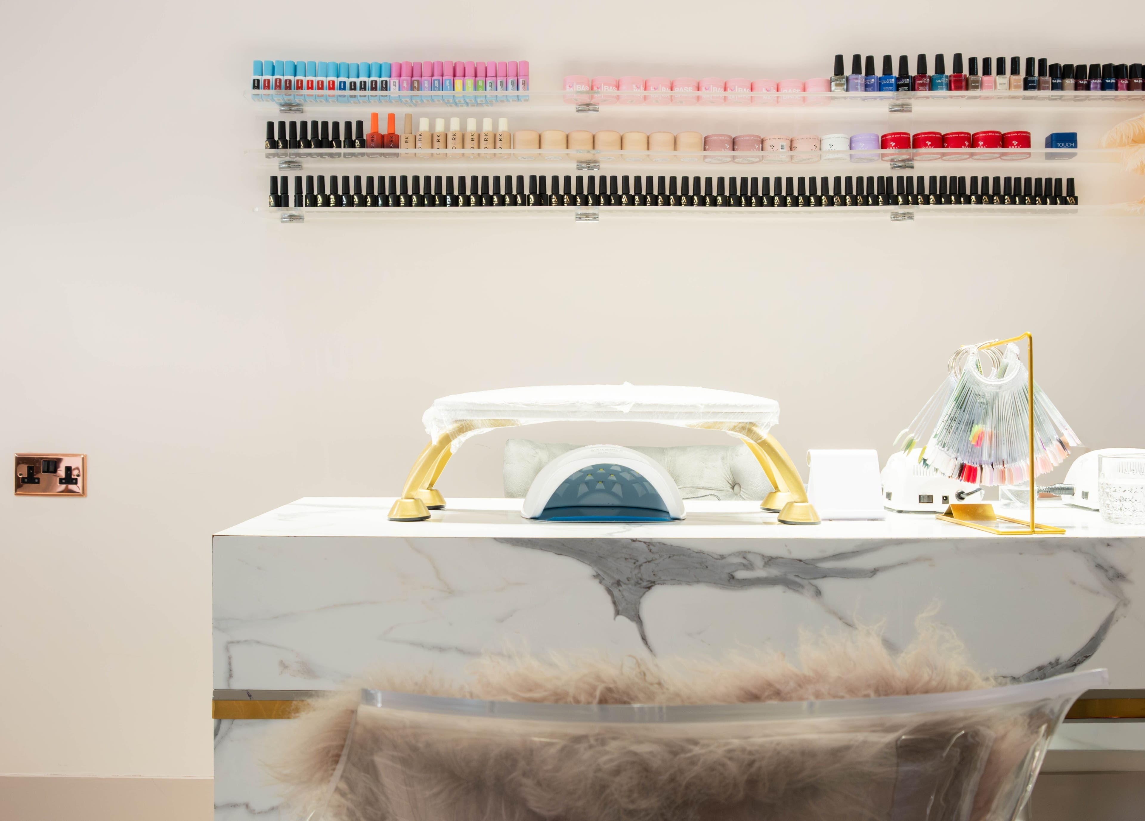 NOGTI Nails Fitzrovia nail station in London, England, GB with colorful polish on display.