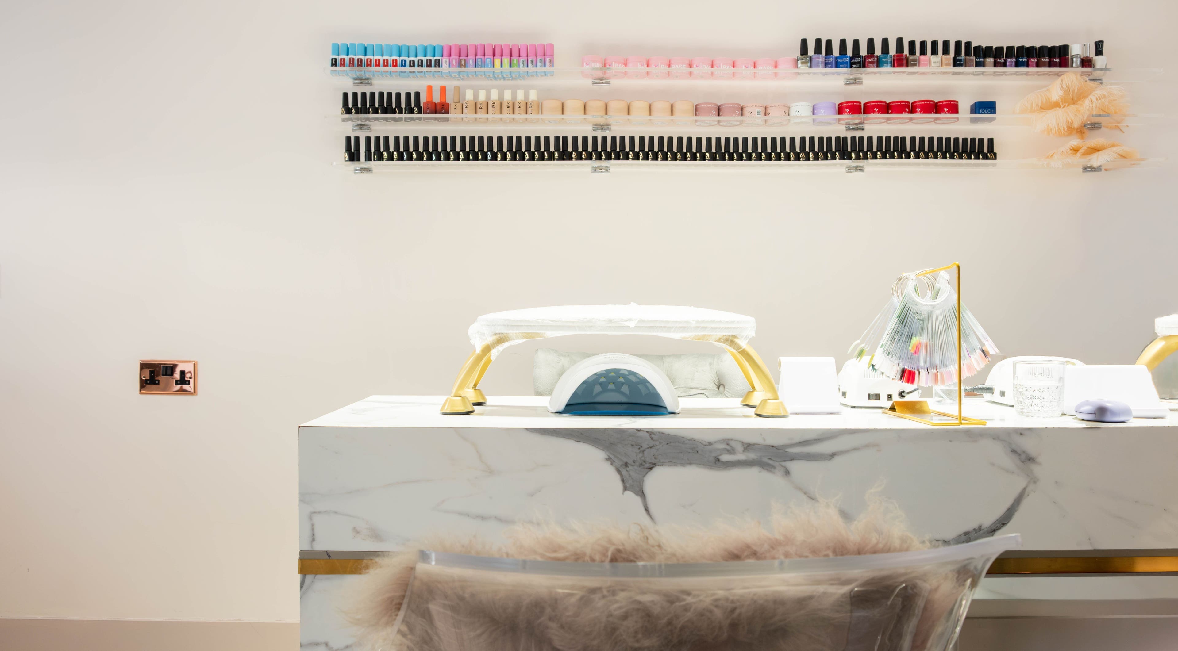 NOGTI Nails Fitzrovia nail station in London, England, GB with colorful polish on display.