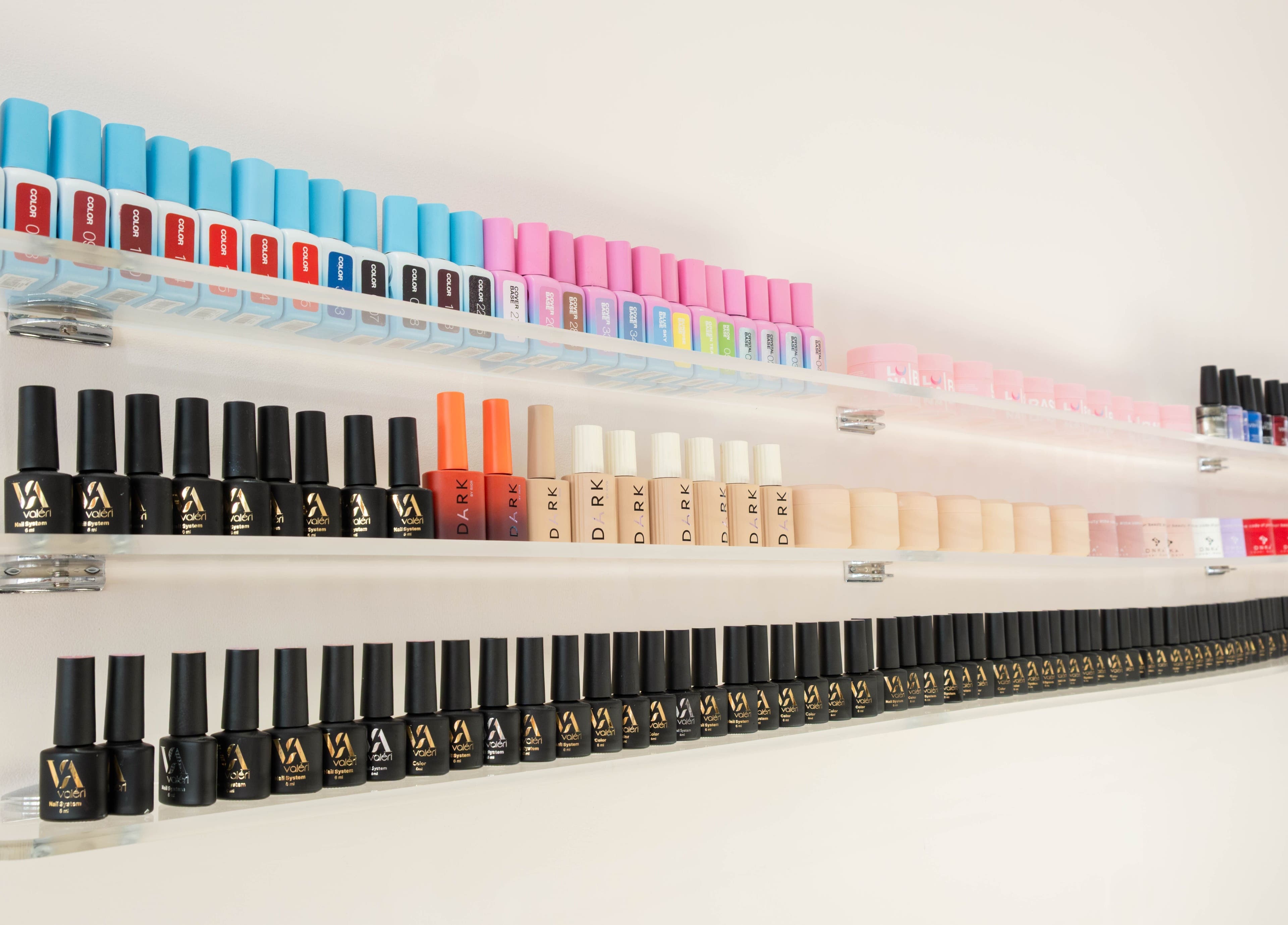 Nail polish display at NOGTI Nails Fitzrovia, London, England, GB showcasing vibrant nail colors.