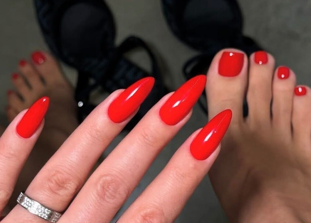 Striking red manicure and pedicure at NOGTI Nails Fitzrovia, London, England, GB.