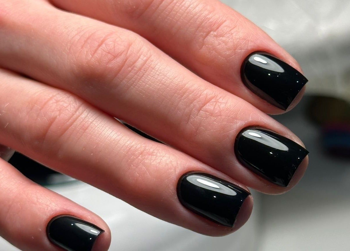 Elegant black manicure at NOGTI Nails Fitzrovia, London, England, GB showcasing sleek, glossy finish.