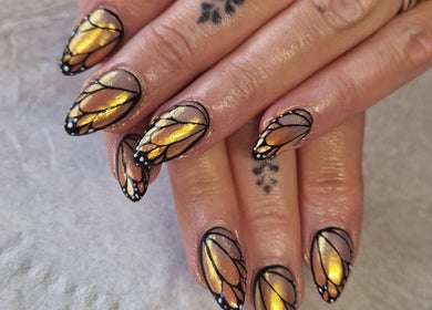 Butterfly wing nail art with golden glitter at Celestial Nails Balloch, Balloch, Scotland, GB.