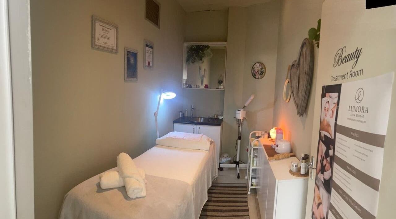 Treatment room at Lumora Skin Studio in Kloof Hillcrest, Kwazulu Natal, featuring a massage table and calming decor.