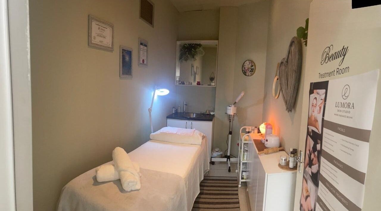 Treatment room at Lumora Skin Studio in Kloof Hillcrest, Kwazulu Natal, featuring a massage table and calming decor.