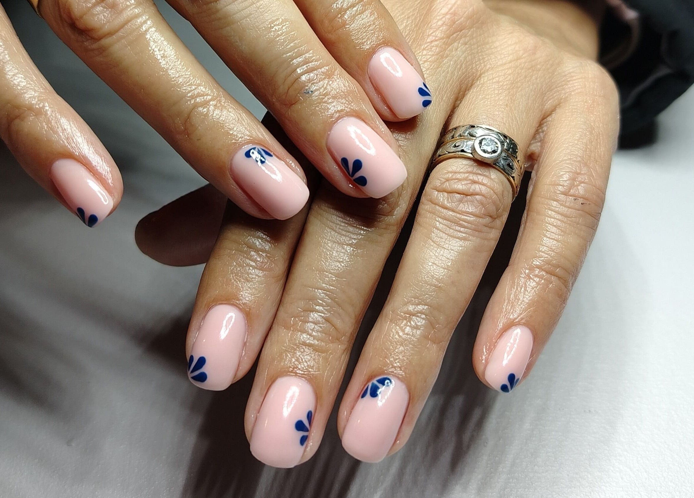 Detailed nail art with blue petals at Nailed by Lue in Riversdale, Western Cape, ZA.