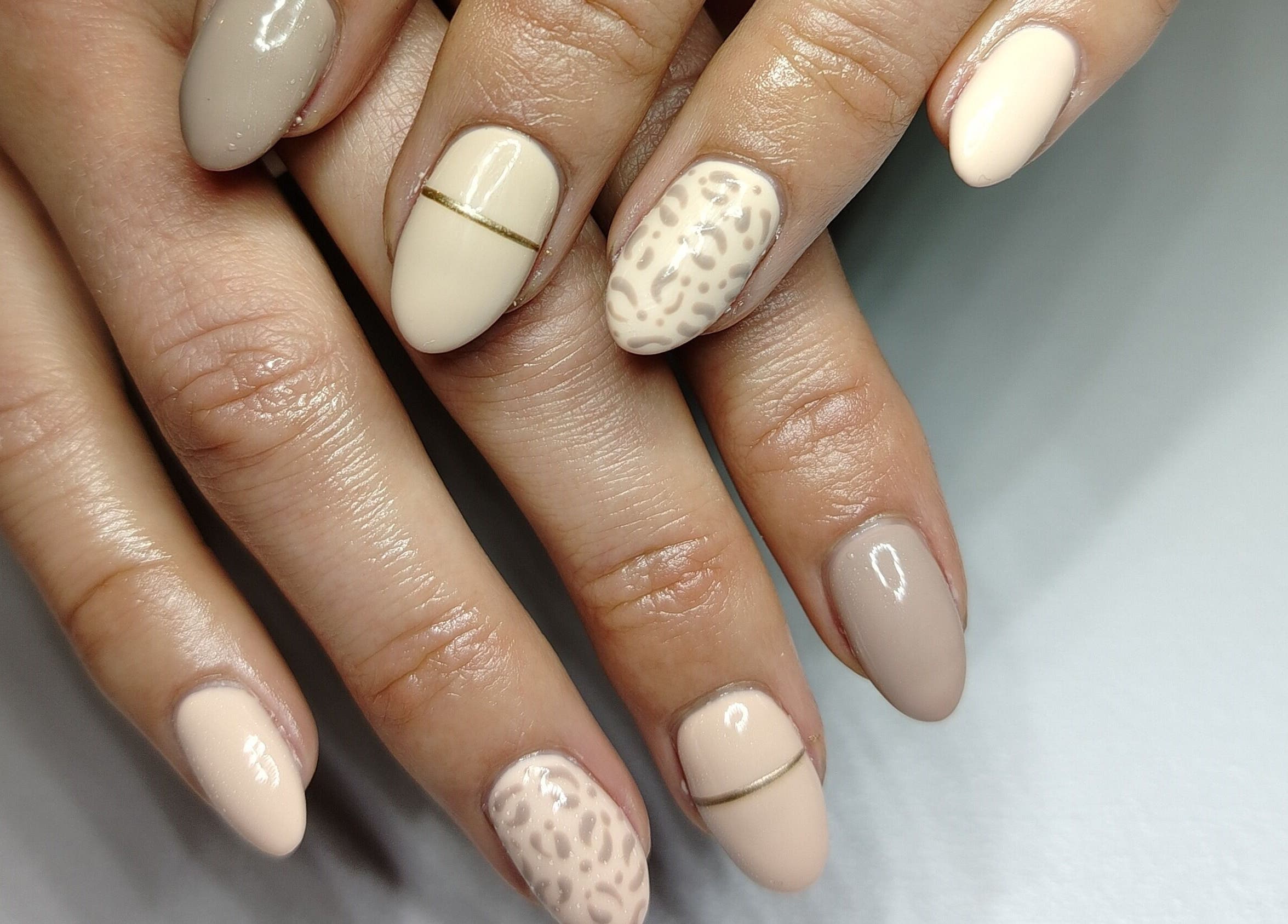 Elegant nail art at Nailed by Lue in Riversdale, Western Cape, ZA showcasing nude and leopard designs.