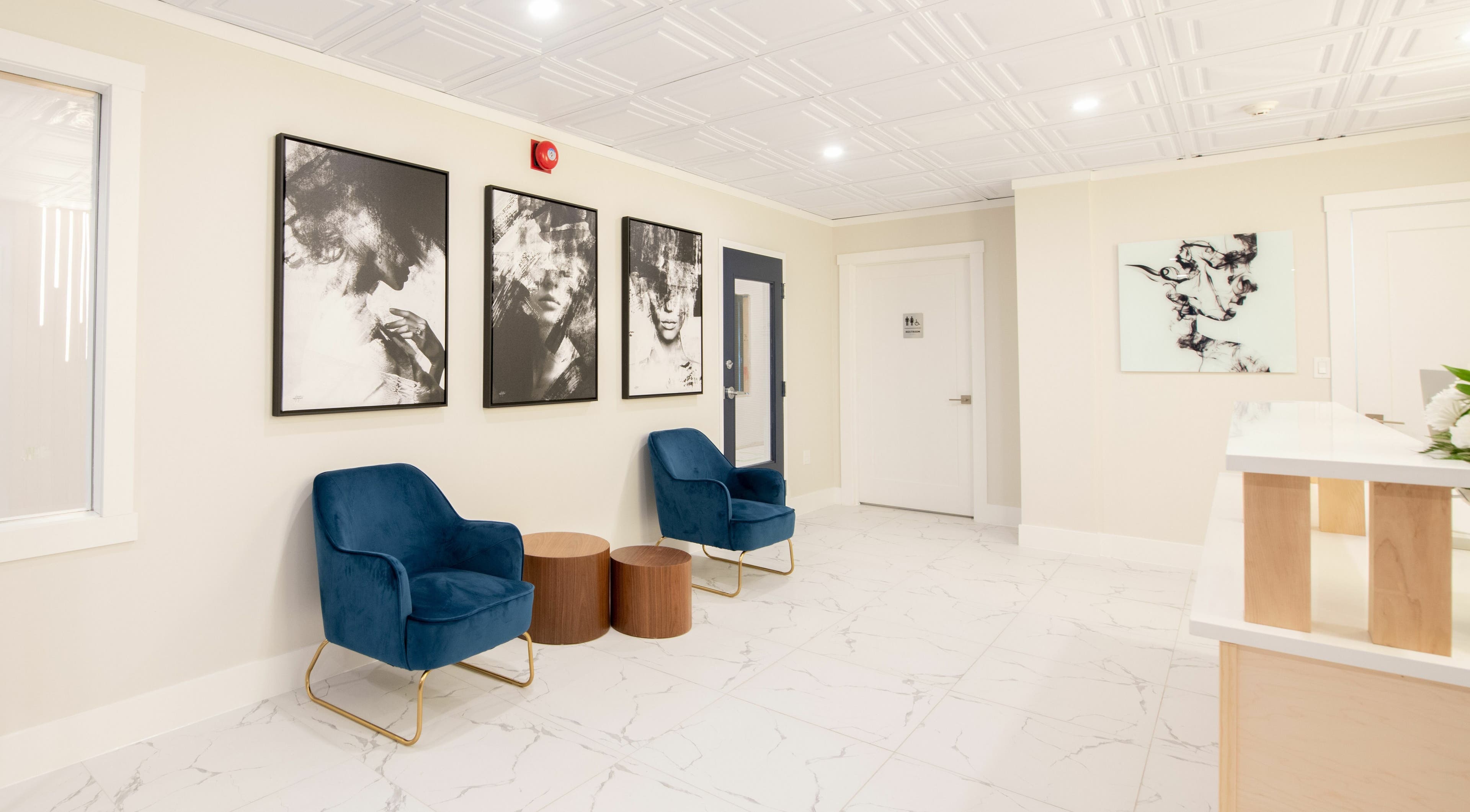 Modern waiting area with blue chairs and artwork at RADIANCE Dental Hygiene and Teeth Whitening, Halifax, Nova Scotia, CA.