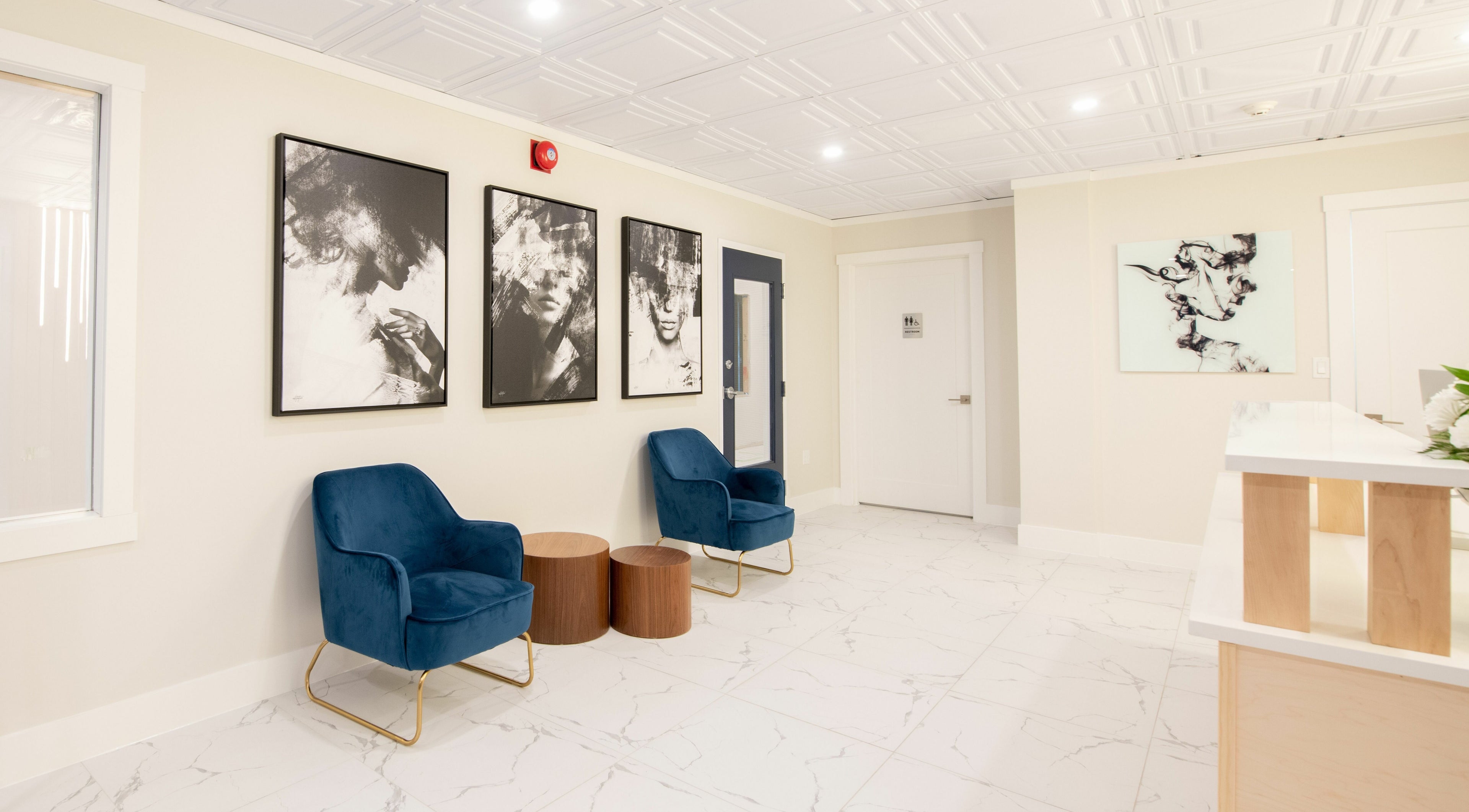 Modern waiting area with blue chairs and artwork at RADIANCE Dental Hygiene and Teeth Whitening, Halifax, Nova Scotia, CA.