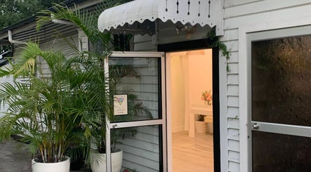 Inviting entrance of Grake Hair in Kelvin Grove, Queensland, AU, with plants and welcoming decor.