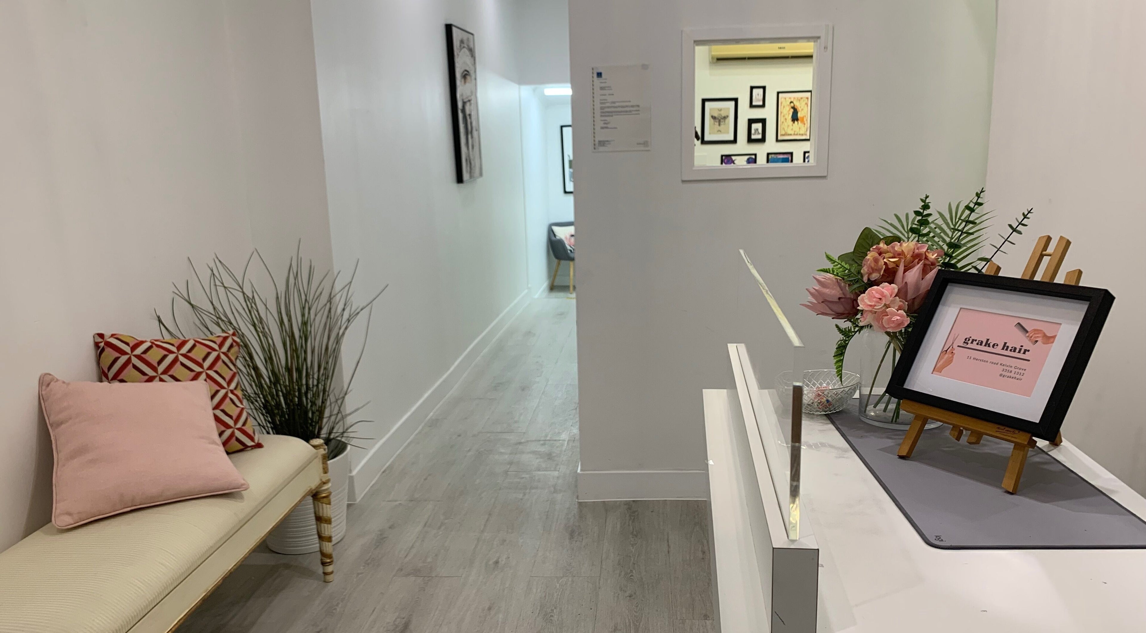Inviting hallway at Grake Hair, Kelvin Grove, Queensland, AU, with elegant decor and welcoming atmosphere.