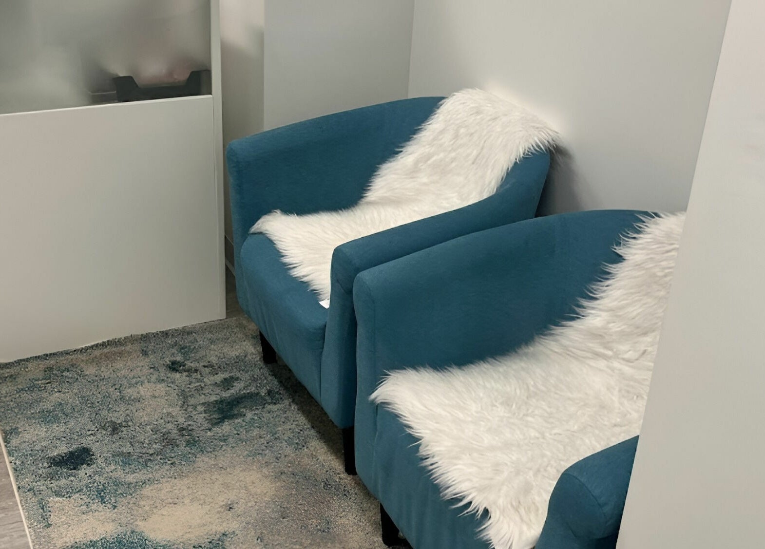Comfortable blue chairs with faux fur at Unique Massage Spa, Fairfax, Virginia, US awaiting relaxation.