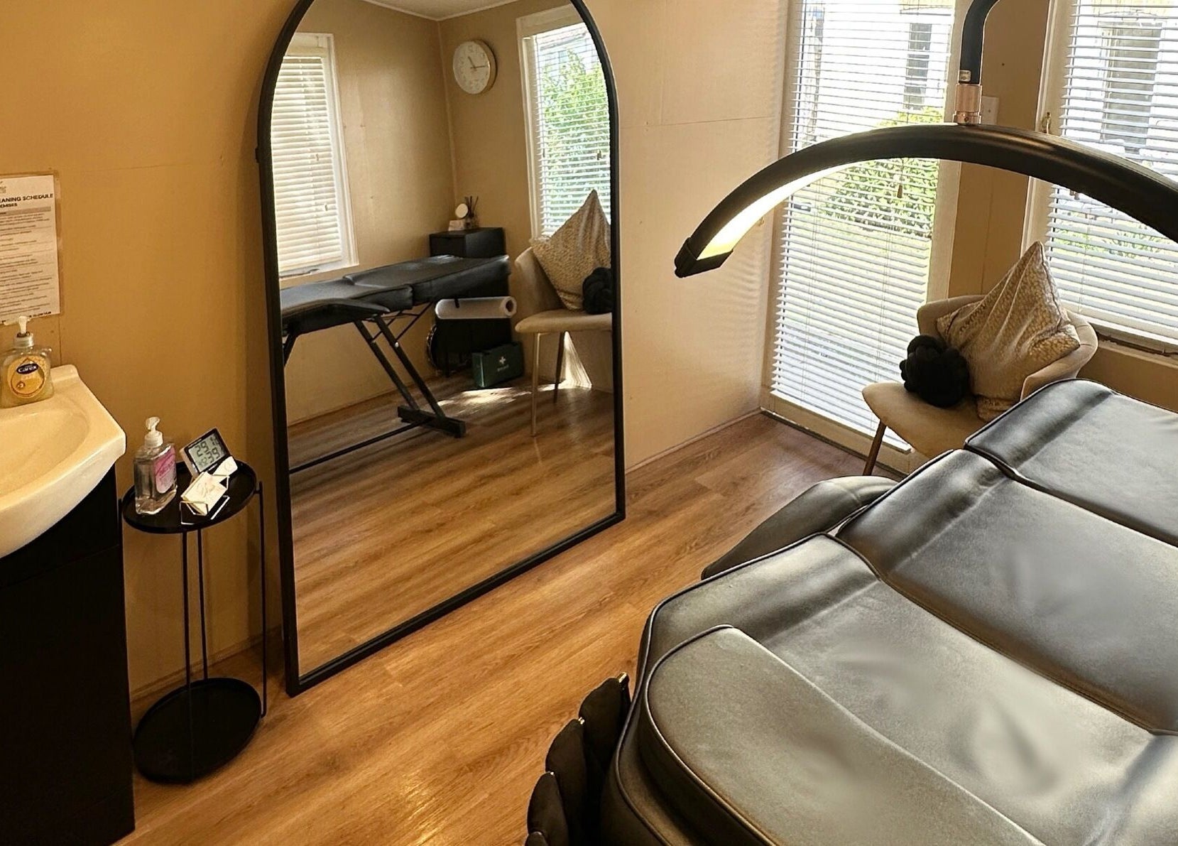 Spa room at The Glow Hub in Black Notley, England, GB featuring a massage bed and modern decor.