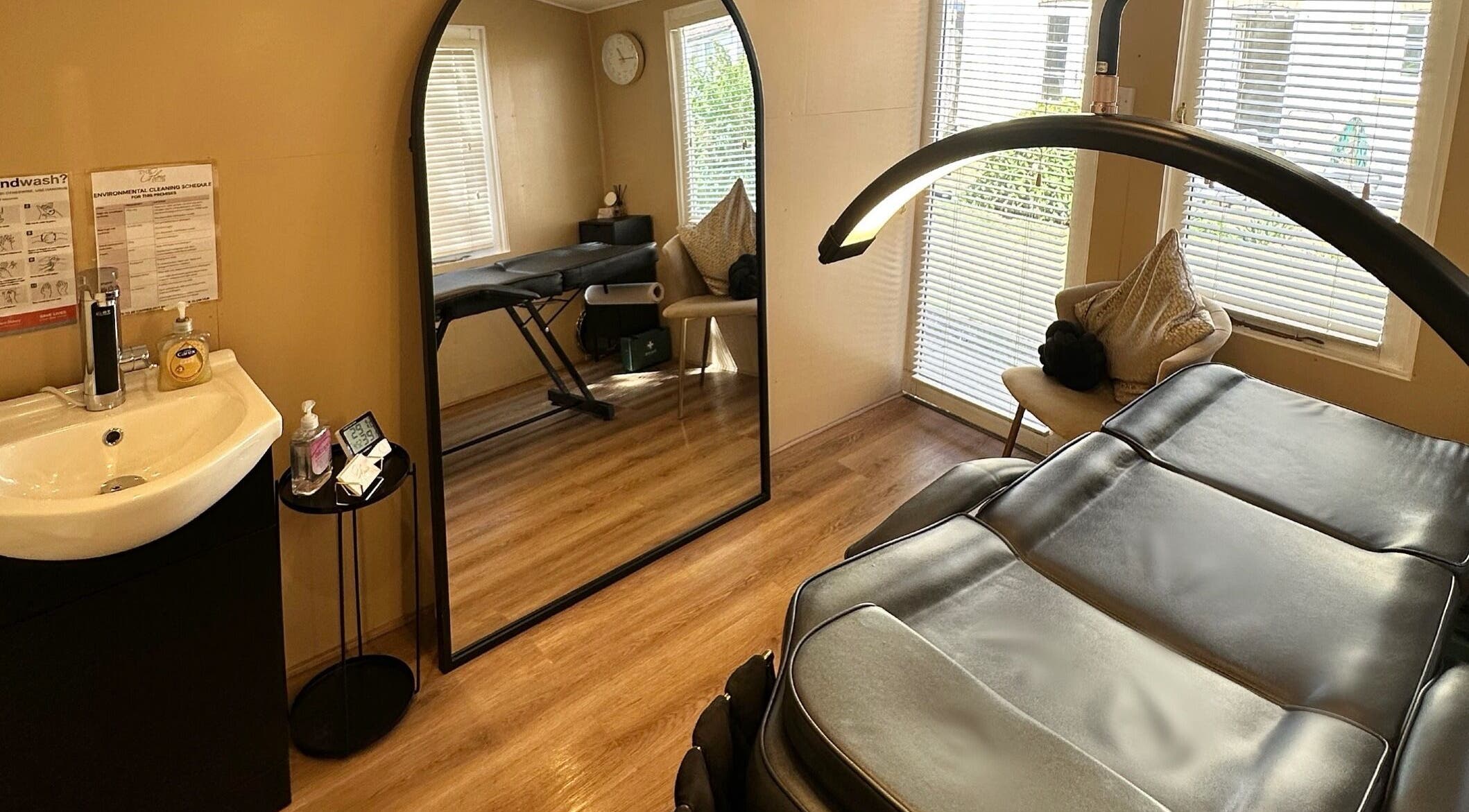 Spa room at The Glow Hub in Black Notley, England, GB featuring a massage bed and modern decor.